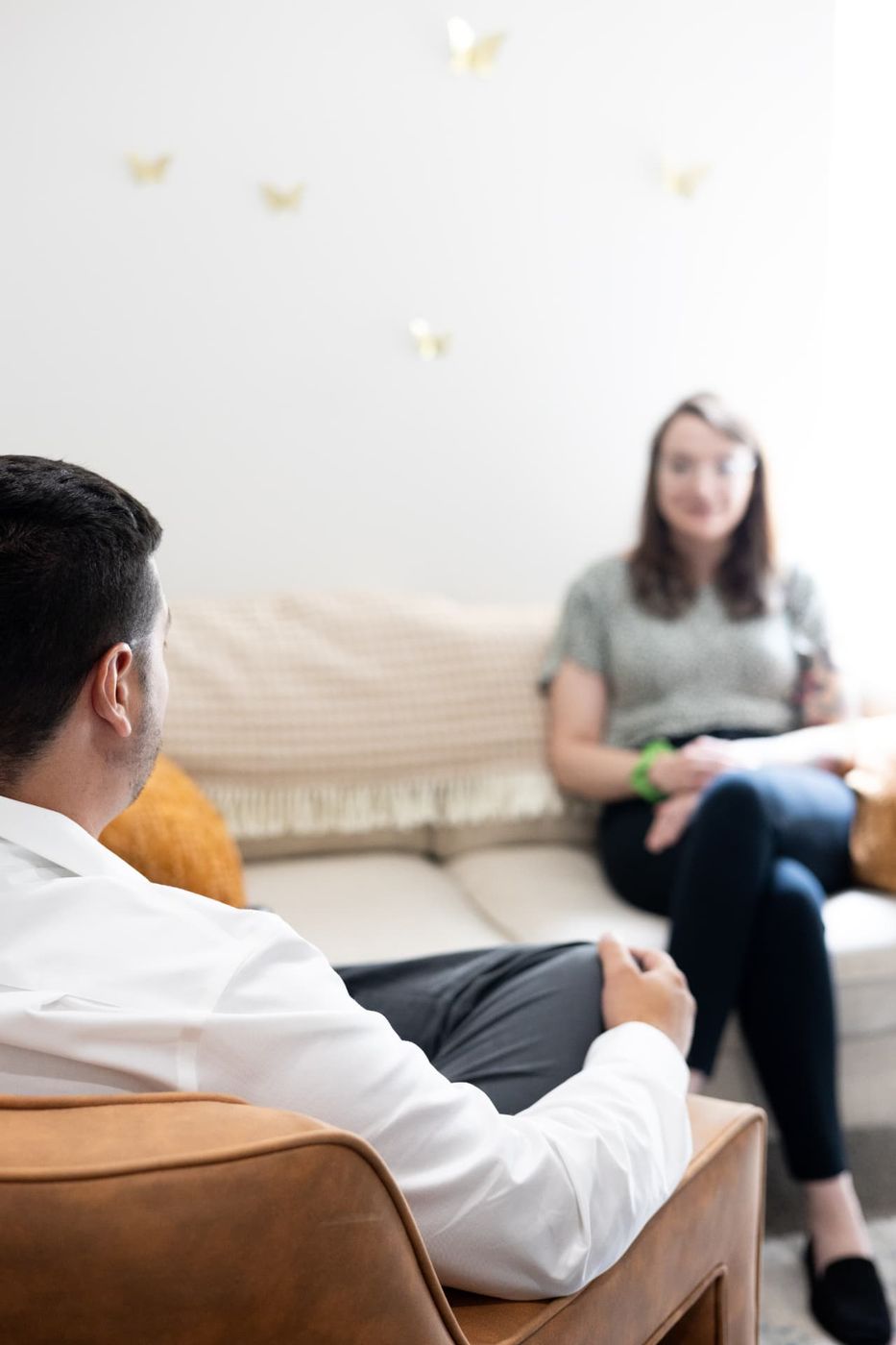 A client and therapist talking in a bright Compass of Hope office