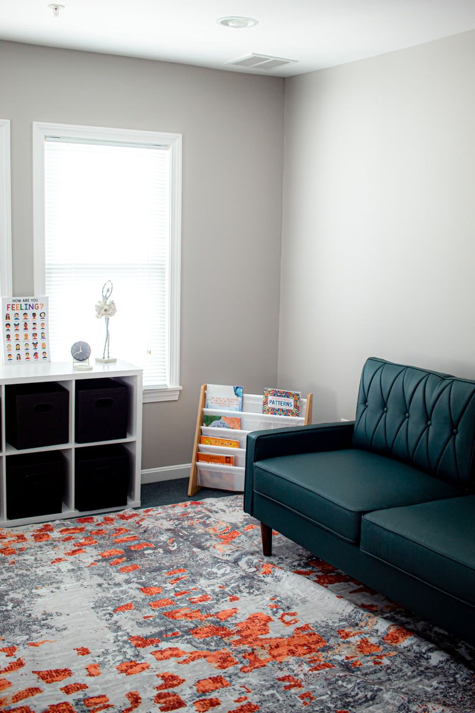 A Compass of Hope office with a sofa, children’s books, and a feelings chart